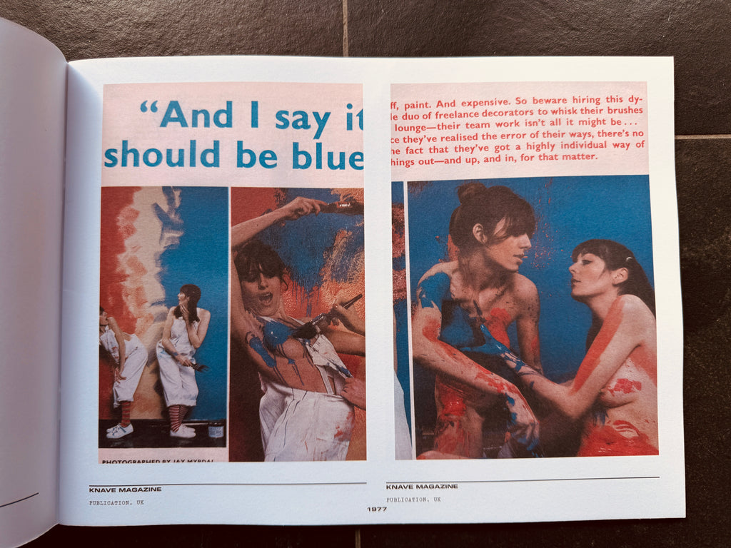 Open book with artistic illustrations and text on a dark surface