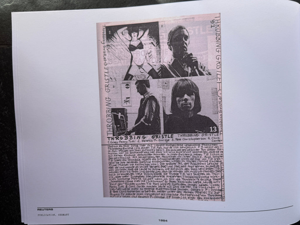 Open book with black and white newspaper clippings and images on a dark background