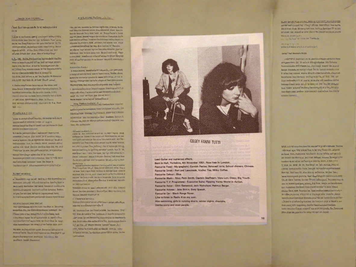 Open book with a black and white photo and text on a dark surface