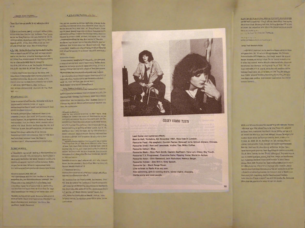 Open book with a black and white photo and text on a dark surface