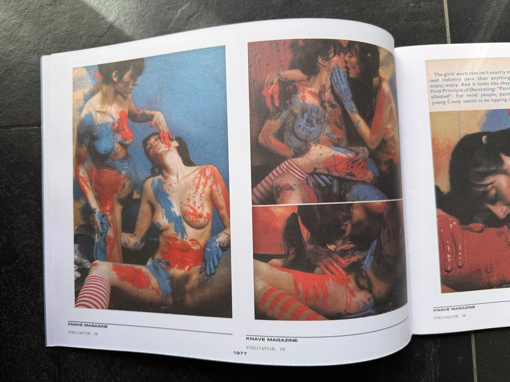 Open book displaying art illustrations of women with tattoos on a dark surface